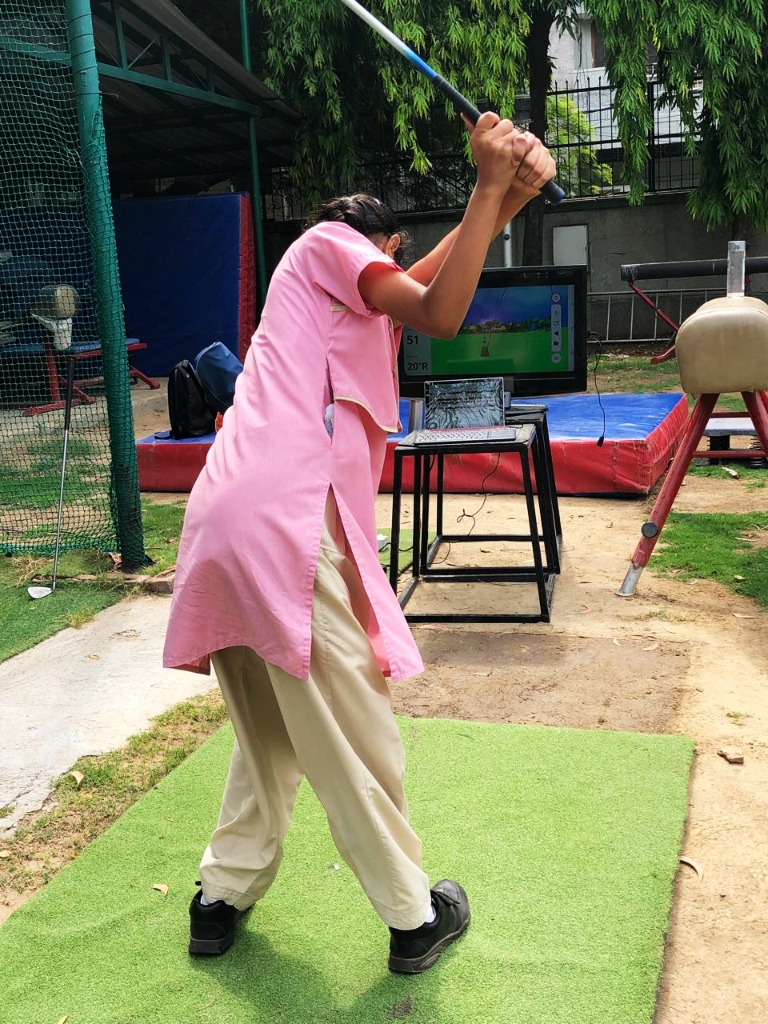 Student practicing swing telemetry with simulator setup