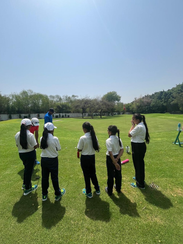 TGR student girls practicing putting on golf course
